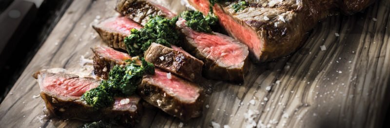 Slices of beef on a wooden tray