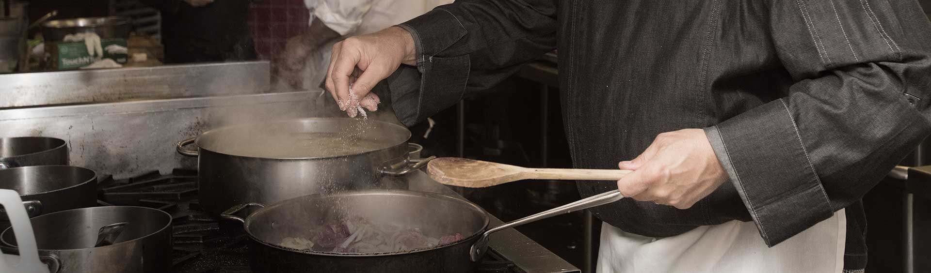 Chef cooking over a stove