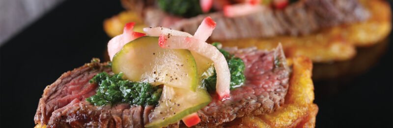 Close up of crostini with steak slice