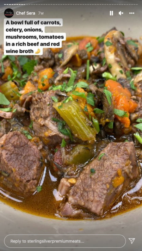 Bowl of beef stew with carrots, celery, onions, mushroom, and tomatoes