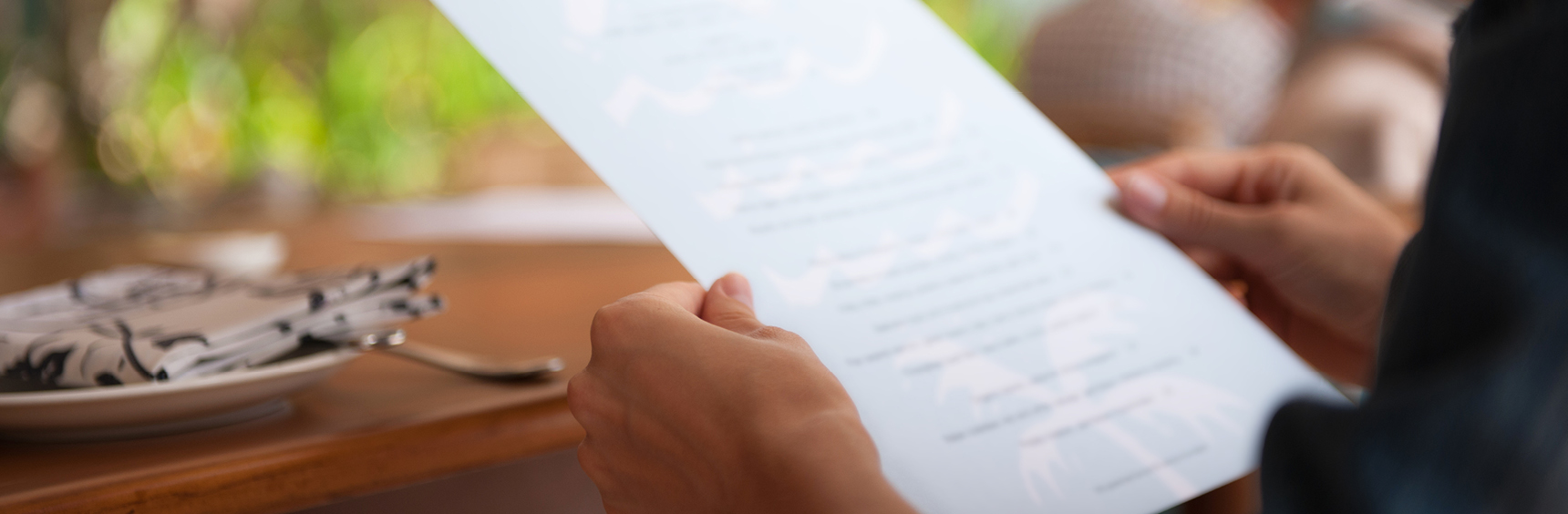 Person holding a menu