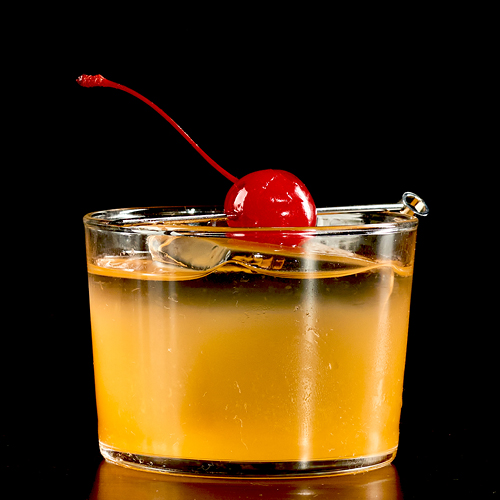 Nonalcoholic Old Fashioned with barley tea, angostura bitters, sugar cube, orange slice and maraschino cherry.