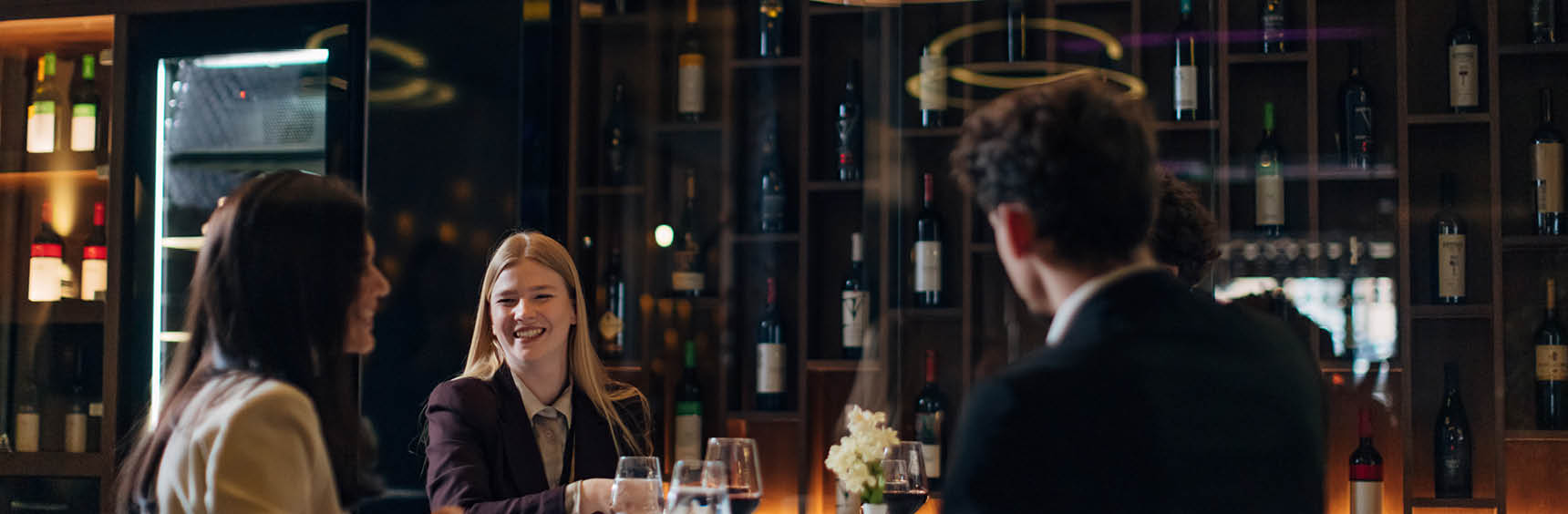 People chatting and laughing at a restaurant table